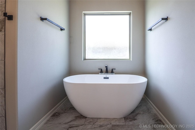 1440 Mabelle Dr, Sapulpa, OK 74066 - full bathroom with a freestanding tub, baseboards, and marble finish floor