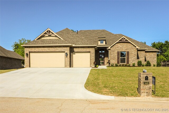 1440 Mabelle Dr, Sapulpa, OK 74066 - view of front of house featuring roof with shingles, driveway, a garage, brick siding, and a front yard