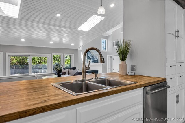 3334 S Wheeling Ave, Tulsa, OK 74105 - kitchen with recessed lighting, a sink, wood counters, a skylight, and dishwasher