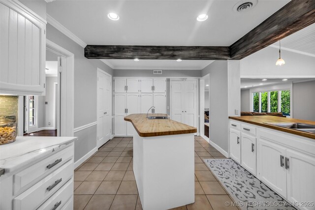 3334 S Wheeling Ave, Tulsa, OK 74105 - kitchen featuring a sink, wooden counters, visible vents, and white cabinetry