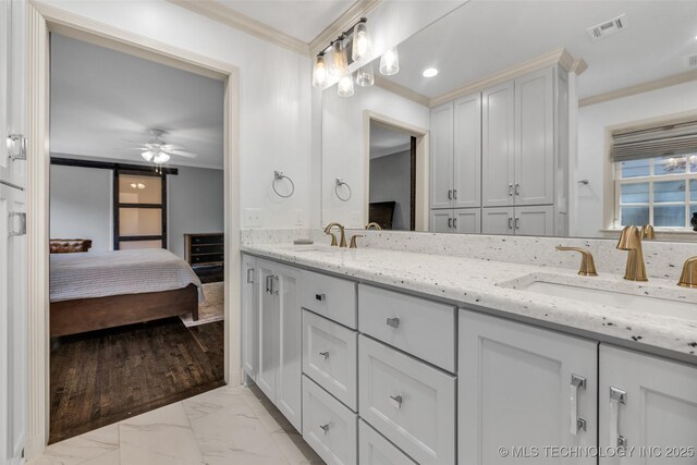 3334 S Wheeling Ave, Tulsa, OK 74105 - ensuite bathroom with visible vents, crown molding, marble finish floor, and a sink
