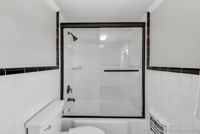 3334 S Wheeling Ave, Tulsa, OK 74105 - bathroom featuring toilet, tile walls, and combined bath / shower with glass door