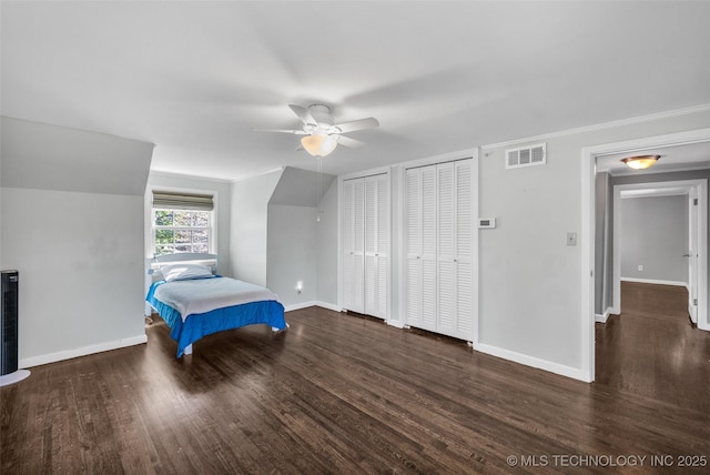 3334 S Wheeling Ave, Tulsa, OK 74105 - unfurnished bedroom with wood finished floors, multiple closets, ceiling fan, baseboards, and visible vents