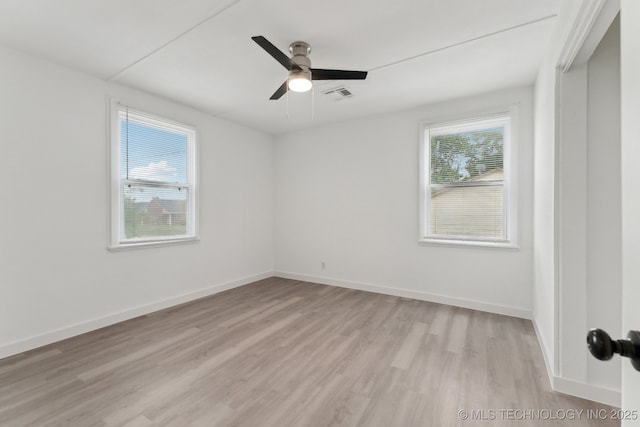 unfurnished room featuring baseboards, visible vents, a ceiling fan, and light wood-style flooring