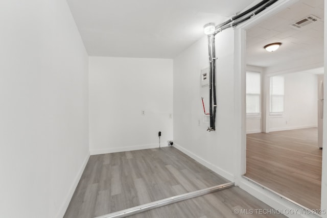 interior space featuring visible vents, wood finished floors, and baseboards