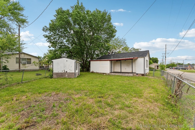 view of yard featuring an outdoor structure, a shed, and a fenced backyard