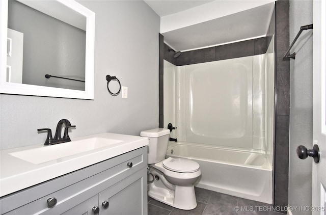 full bathroom featuring vanity, tile patterned flooring, toilet, and shower / tub combination