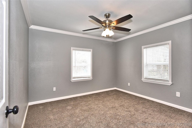 empty room featuring baseboards, ornamental molding, carpet, and a ceiling fan