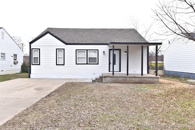 view of front of home featuring a shingled roof and covered porch