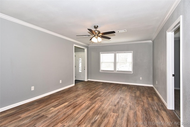 empty room featuring crown molding, ceiling fan, visible vents, and dark wood-style floors