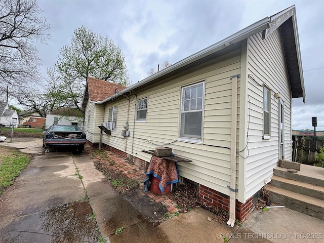 view of property exterior with concrete driveway