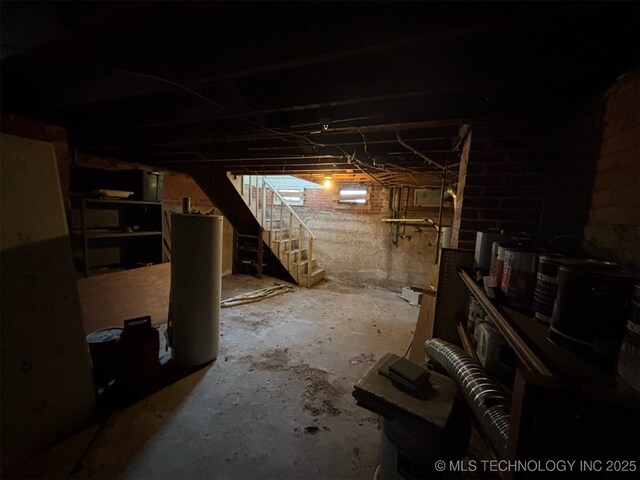 unfinished basement with water heater and stairway