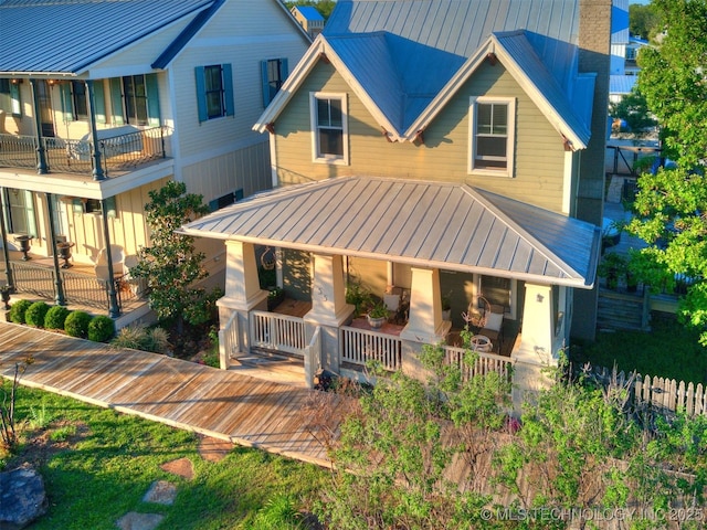 55 Boardwalk, Carlton Landing, OK 74432 - view of front facade with a porch, metal roof, a standing seam roof, and a chimney