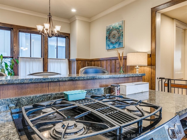55 Boardwalk, Carlton Landing, OK 74432 - detailed view of a wainscoted wall, crown molding, a chandelier, decorative light fixtures, and stovetop with downdraft