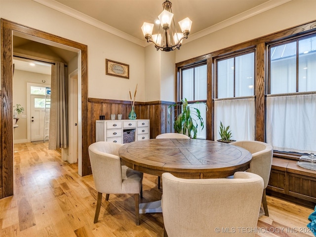 55 Boardwalk, Carlton Landing, OK 74432 - dining room with a chandelier, light wood-type flooring, ornamental molding, wainscoting, and wood walls
