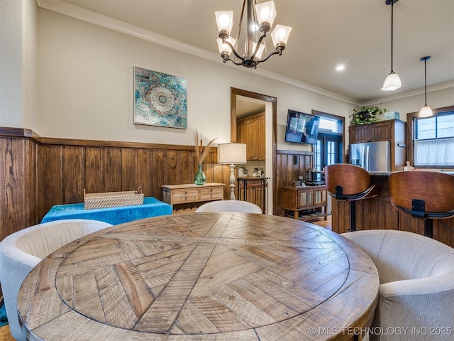 55 Boardwalk, Carlton Landing, OK 74432 - dining space featuring wainscoting, a chandelier, ornamental molding, and wood walls