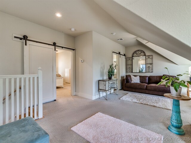 55 Boardwalk, Carlton Landing, OK 74432 - carpeted living room featuring a barn door, baseboards, vaulted ceiling, and recessed lighting