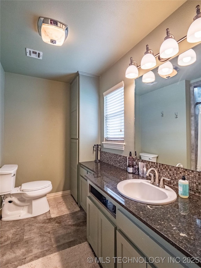 509 Dove Dr, Mcalester, OK 74501 - bathroom with visible vents, toilet, and vanity