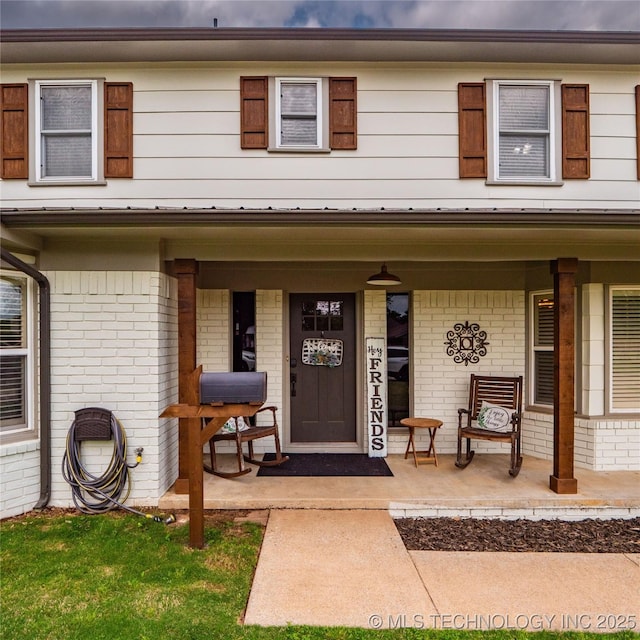 509 Dove Dr, Mcalester, OK 74501 - doorway to property featuring a porch and brick siding