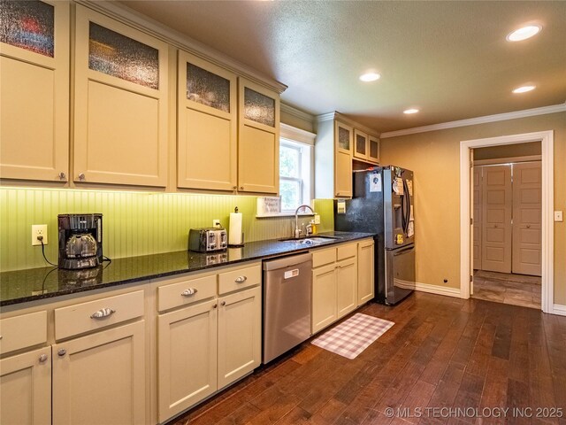 509 Dove Dr, Mcalester, OK 74501 - kitchen featuring crown molding, dark wood-style flooring, recessed lighting, a sink, and stainless steel appliances