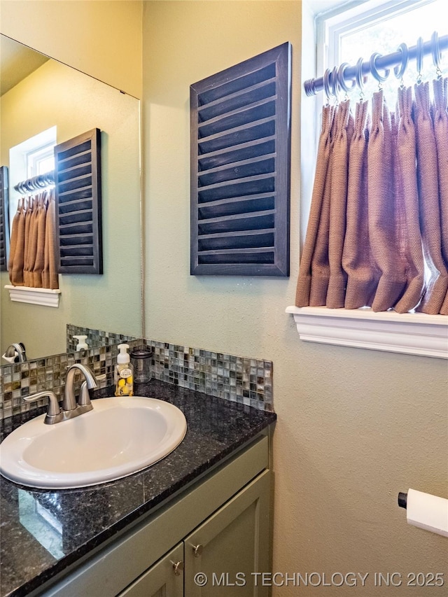509 Dove Dr, Mcalester, OK 74501 - bathroom with tasteful backsplash and vanity
