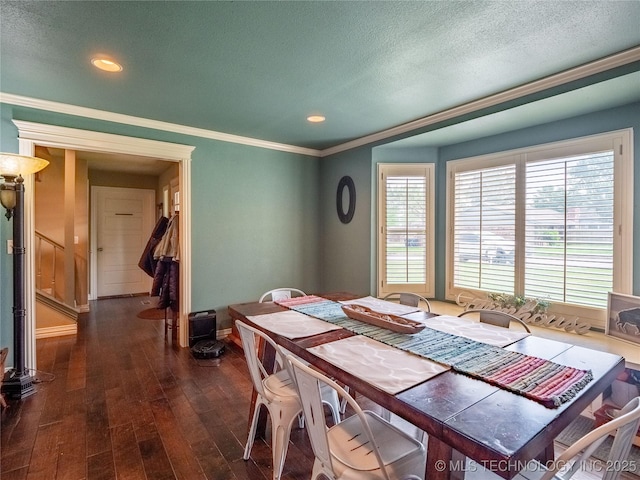 509 Dove Dr, Mcalester, OK 74501 - dining area featuring crown molding, a textured ceiling, baseboards, and dark wood finished floors