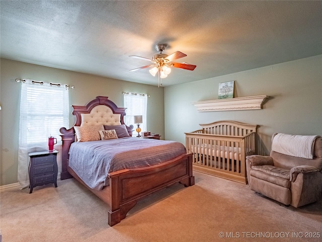 509 Dove Dr, Mcalester, OK 74501 - carpeted bedroom with baseboards, ceiling fan, and a textured ceiling