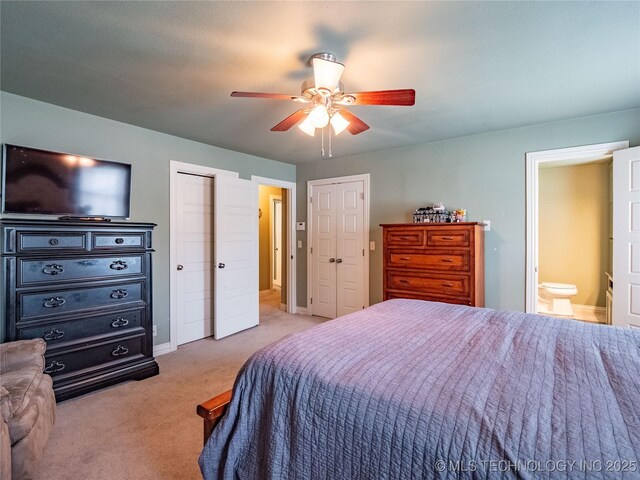 509 Dove Dr, Mcalester, OK 74501 - bedroom with multiple closets, light carpet, baseboards, ensuite bathroom, and a ceiling fan