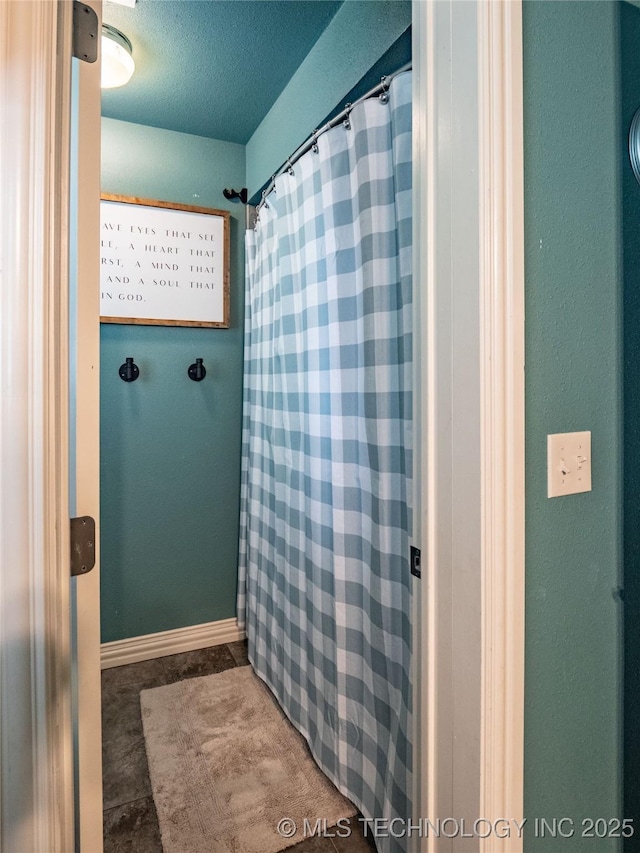 509 Dove Dr, Mcalester, OK 74501 - bathroom featuring baseboards and a shower with shower curtain