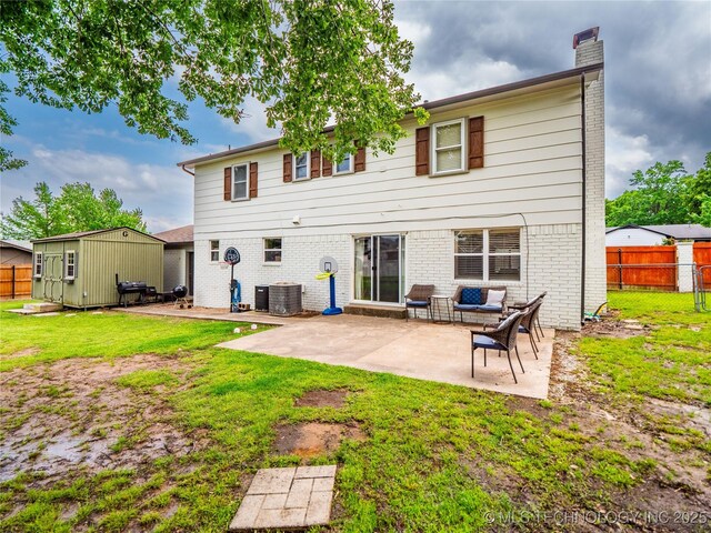 509 Dove Dr, Mcalester, OK 74501 - back of property with brick siding, fence, a chimney, and a patio