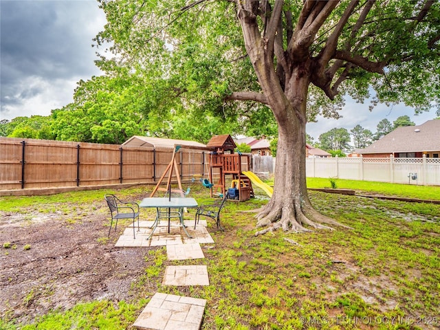 509 Dove Dr, Mcalester, OK 74501 - view of yard featuring a playground, a patio, and a fenced backyard