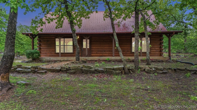 view of front facade with metal roof and log exterior
