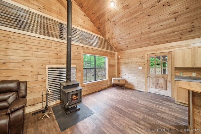 sitting room featuring wood ceiling, wood walls, high vaulted ceiling, a wood stove, and dark wood-style floors