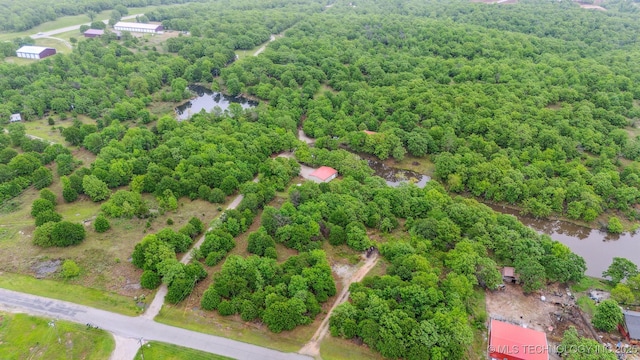 birds eye view of property with a water view and a view of trees