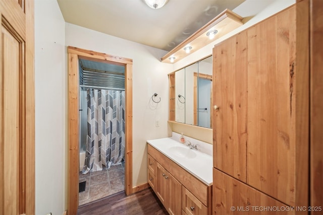 full bathroom with shower / bath combination with curtain, wood finished floors, and vanity