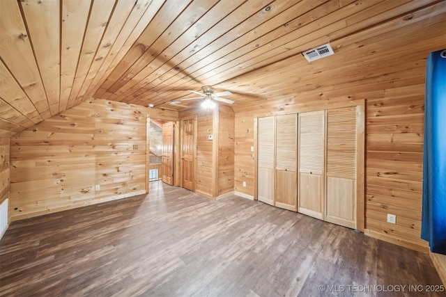 bonus room featuring wood finished floors, visible vents, wooden walls, a ceiling fan, and wood ceiling