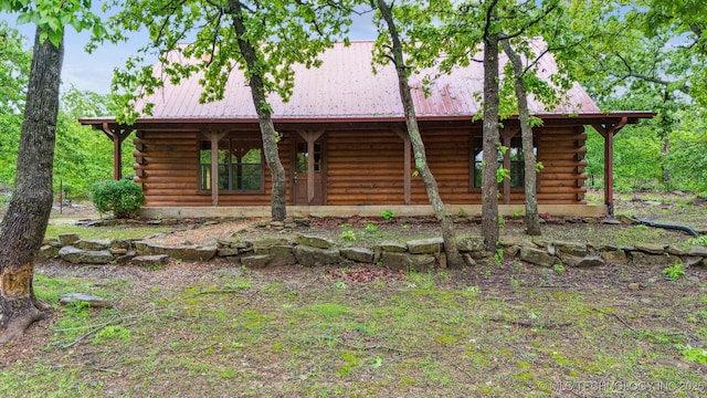 view of front facade with metal roof and log exterior