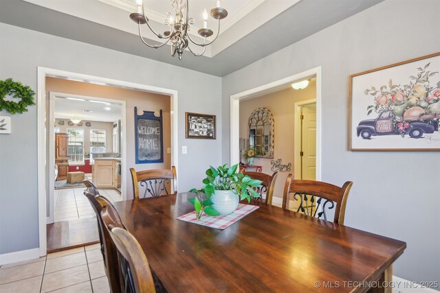 dining space featuring an inviting chandelier, baseboards, and light tile patterned floors