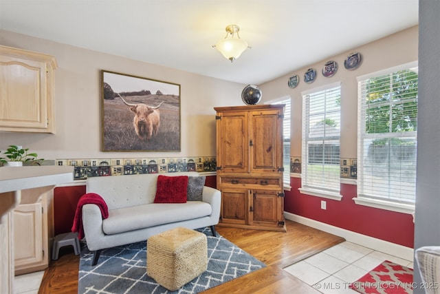 living room with light wood-type flooring and baseboards