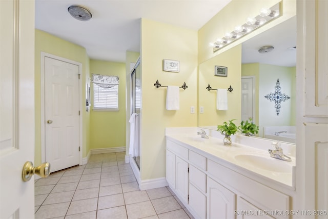 bathroom featuring double vanity, tile patterned floors, a shower stall, and a sink