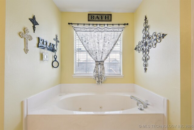 full bathroom with a whirlpool tub