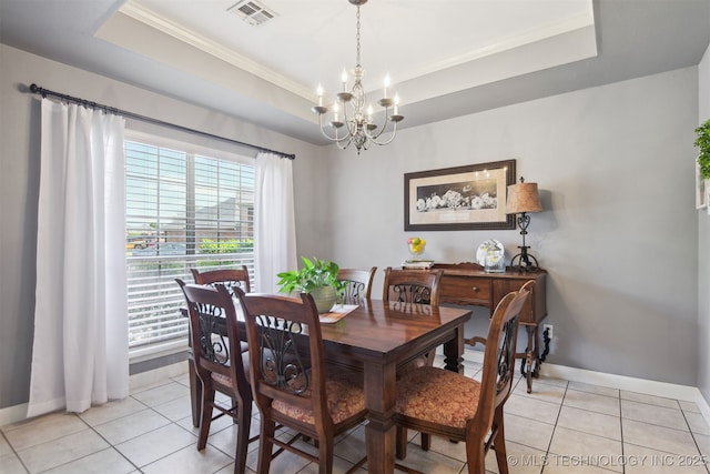 dining area with ornamental molding, a tray ceiling, a chandelier, and visible vents