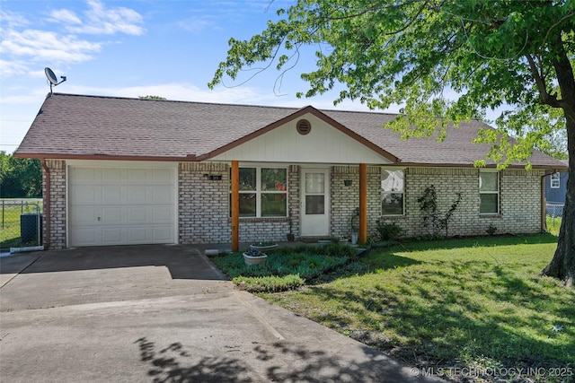 single story home with a garage, brick siding, a front yard, and driveway