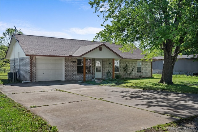 ranch-style home with central AC, a front lawn, driveway, an attached garage, and brick siding