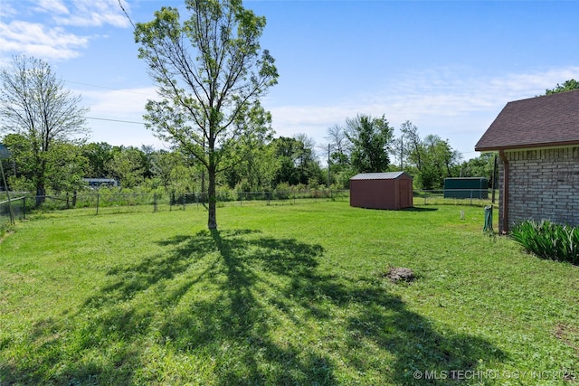 view of yard featuring a fenced backyard, an outbuilding, and a shed