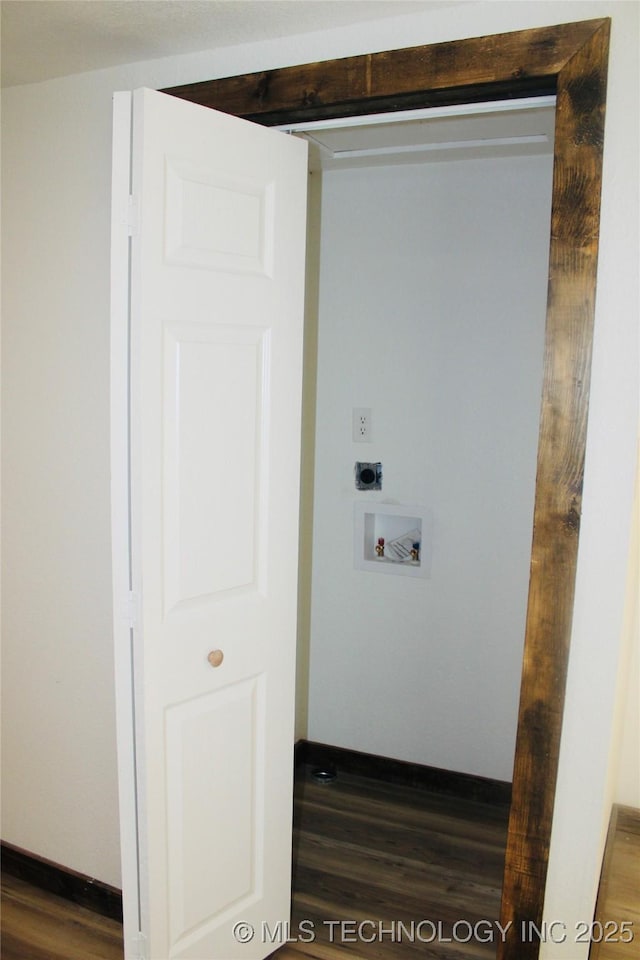 washroom with laundry area, dark wood-type flooring, electric dryer hookup, hookup for a washing machine, and baseboards