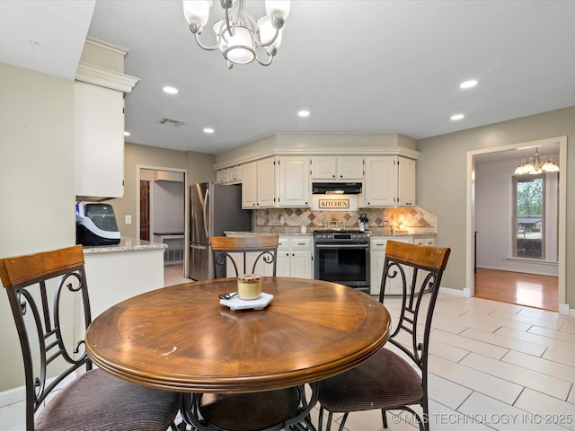 dining area featuring an inviting chandelier, visible vents, recessed lighting, and baseboards
