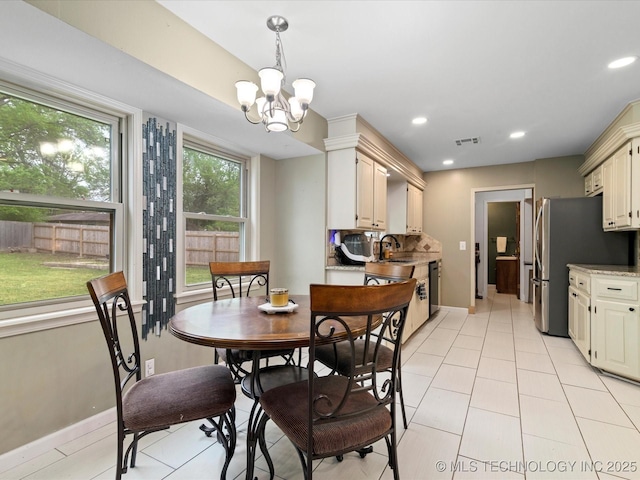 dining room with baseboards, visible vents, a notable chandelier, and light tile patterned flooring
