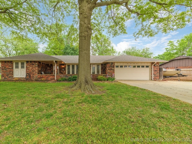 ranch-style home featuring a front yard, concrete driveway, brick siding, and an attached garage