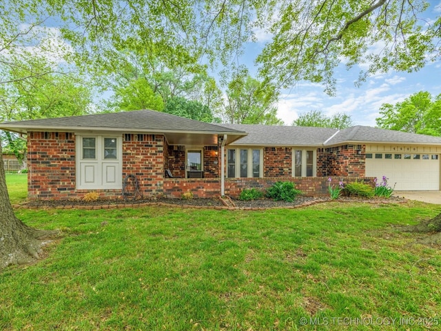 ranch-style home featuring a garage, brick siding, a front yard, and concrete driveway